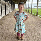 Short sleeve girls dress in a buttery soft blue fabric with horses, sunflowers and roses throughout.