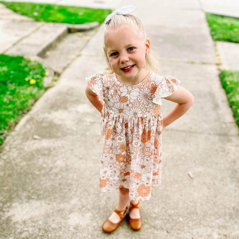 Girls boutique dress.  Pearl style flutter sleeve dress in a neutral floral pattern, paired with our children's boutique bow back ballet shoes in weathered brown.