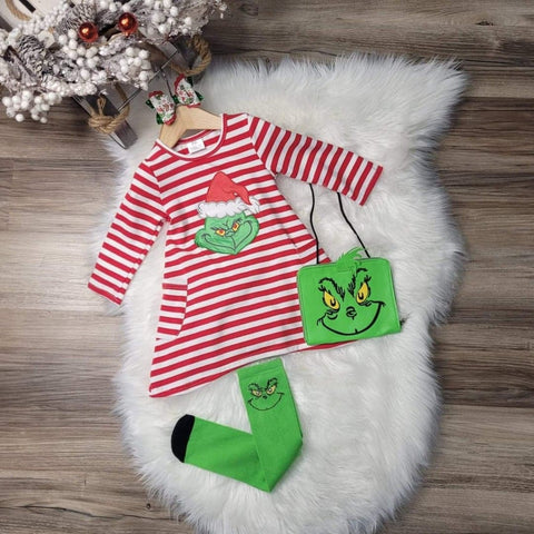 Girls boutique Christmas dress in red and white stripes with Grinch face applique, green Grinch themed socks, and a green purse.