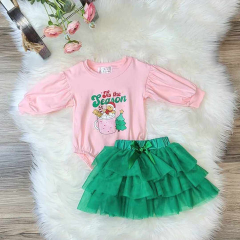 Baby girl pink long sleeve bubble onesie paired with green layered tulle skirt.  Onesie has 'Tis the season on the front.
