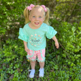 Girls boutique mint "Be Kind" ruffle top and pink daisy shorts.