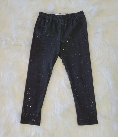 Girls boutique black knit cotton leggings with elastic waist and silver sparkle detail.