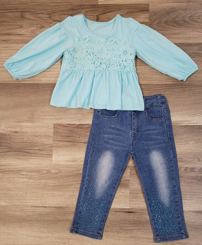 Girls boutique aqua blue bubble sleeve top with lace overlay, paired with denim jeans with blue rhinestone embellishments below knee on front.