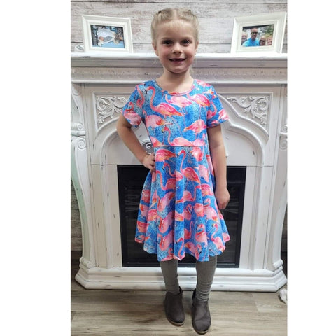 Girls boutique blue short sleeve twirl dress with pink flamingos.