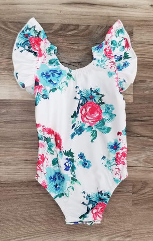 Baby girl flutter sleeve white leo with pink and blue floral print.