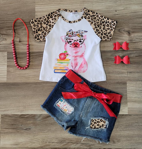 Girls short sleeve leopard sleeve top with pig wearing leopard print glasses, and a  school themed head wrap is paired with denim shorts with school themed and leopard patches.