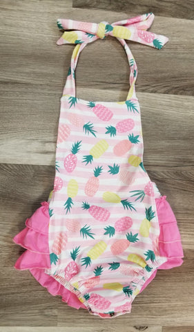 Girls boutique halter tie bubble romper in pineaplle print with ruffle on bottom.