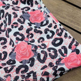 Girls boutique swimwear, close up picture of leopard and pink floral print bikini.
